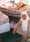 The Grandmother of Abu Aker showing reporters what the soldiers did to her home on Saturday � Photo by IMEMC Ghassan Bannoura.